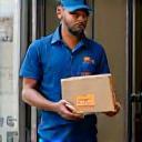 Courier delivering to city apartment doorstep (416x288)